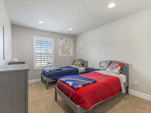 Bedroom featuring light carpet and recessed lighting