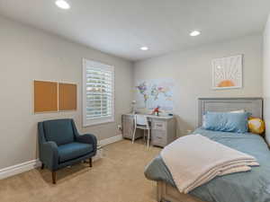 Carpeted bedroom featuring recessed lighting and a desk