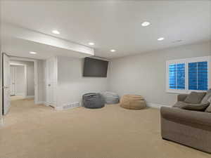 Living area featuring recessed lighting and light carpet