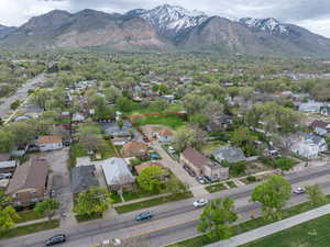Aerial view of residential area featuring a mountainous background and property parcel outlined
