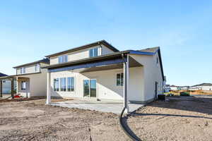 Back of property with a patio area and stucco siding