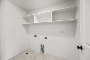 Laundry room featuring light marble finish flooring, washer hookup, and hookup for an electric dryer