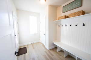 Mudroom featuring light wood-type flooring and baseboards