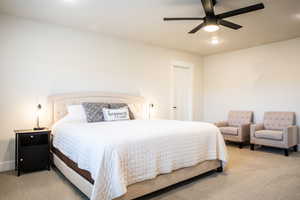 Carpeted bedroom featuring ceiling fan and recessed lighting