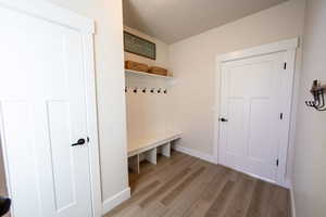 Mudroom featuring baseboards and light wood-style floors