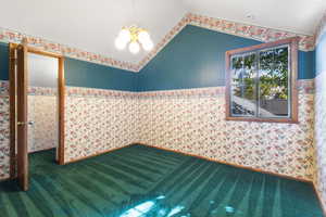 Loft bedroom with vaulted ceilings and a walk-in closet.