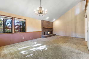 Vaulted living room with brick fireplace.