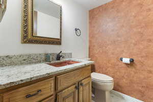 Half bath featuring vanity and toilet