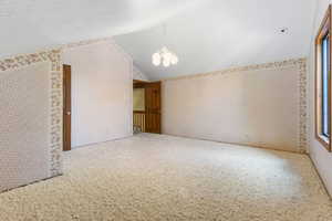 Loft bedroom with vaulted ceilings and a walk-in closet.