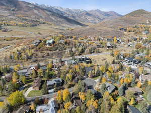 Aerial overview of property's location with nearby suburban area and a mountainous background