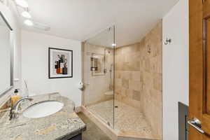 Full bath featuring vanity and walk in shower