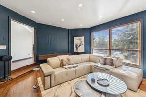 Living area featuring wood finished floors and recessed lighting