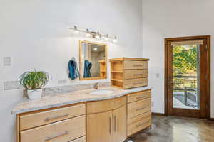 Bathroom with vanity and concrete floors
