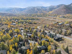 Aerial view of property's location with a mountainous background and nearby suburban area