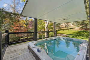 Wooden terrace featuring a yard