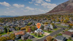 Aerial perspective of suburban area with a mountainous background