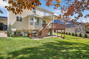 Rear view of property with stairs, a deck, and a patio area