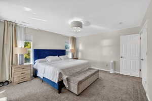 Bedroom featuring carpet floors, a textured ceiling, and a chandelier
