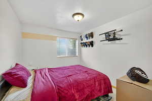 Bedroom featuring a textured ceiling and carpet floors