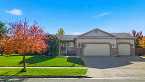 Ranch-style house featuring a front lawn, covered porch, concrete driveway, brick siding, and an attached garage