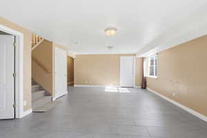 Unfurnished living room with stairway