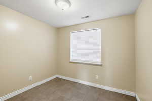 Empty room featuring baseboards and a textured ceiling
