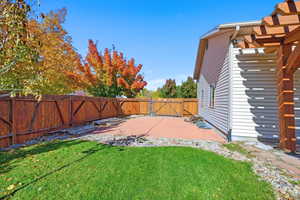 Fenced backyard featuring a patio