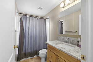 Full bath with shower / bath combo, vanity, and light tile patterned flooring