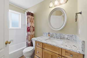 Full bath featuring shower / bathtub combination with curtain and vanity