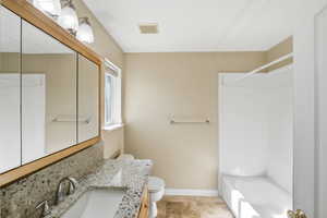 Full bathroom with vanity, washtub / shower combination, and light tile patterned floors