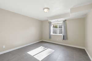 Unfurnished room with baseboards and light tile patterned flooring