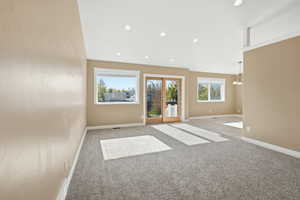 Unfurnished room featuring carpet floors, recessed lighting, and a chandelier