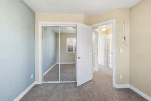 Unfurnished bedroom with carpet floors and a closet