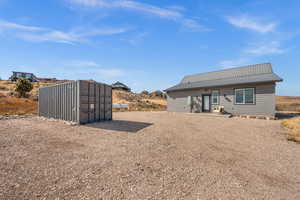 Back of house featuring a metal roof and a patio area