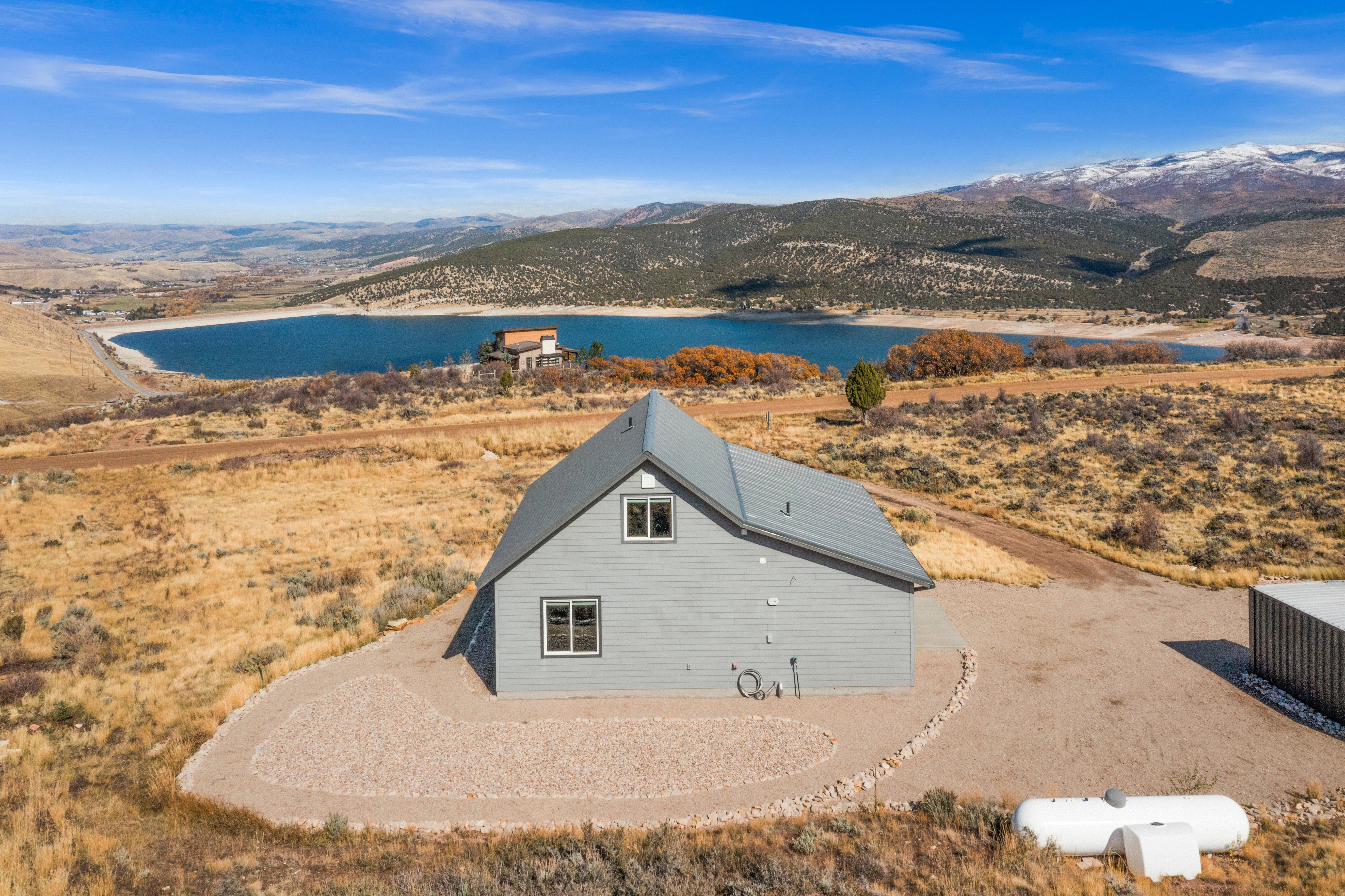 Aerial view of property and surrounding area with a water and mountain view