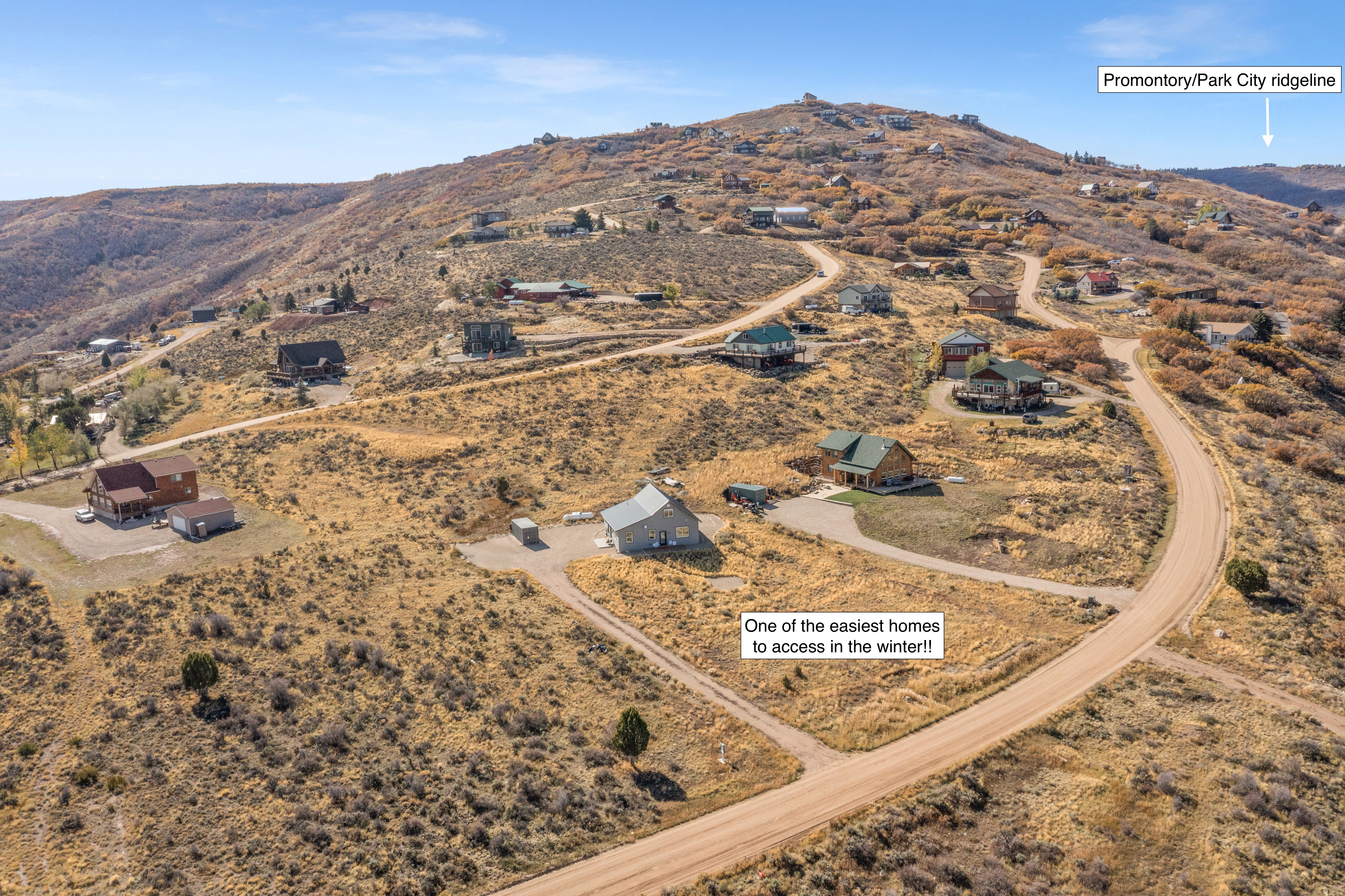 Aerial overview of property's location featuring a mountainous background and rural landscape