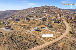 Aerial overview of property's location featuring a mountainous background and rural landscape