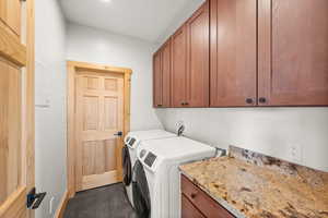 Laundry area featuring cabinet space and independent washer and dryer