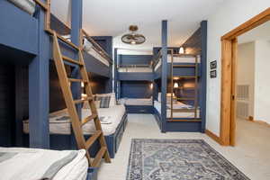 Bedroom featuring light carpet and a textured ceiling