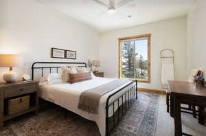 Bedroom with a ceiling fan and baseboards