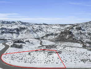Snowy aerial view featuring a mountain view