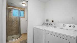 Laundry room with washing machine and dryer and a textured ceiling