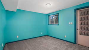 Spare room with carpet floors and a textured ceiling
