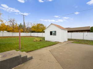 View of shed with a fenced backyard