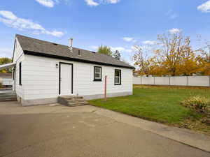 Back of house with a shingled roof