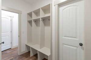 Mudroom featuring dark wood-type flooring and baseboards