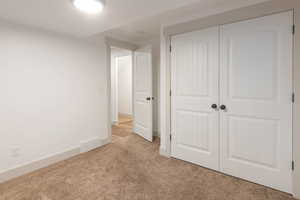 Unfurnished bedroom with a closet and carpet