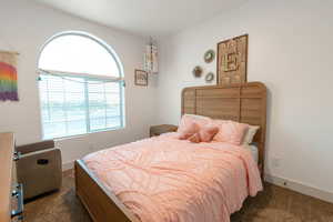 Carpeted bedroom featuring baseboards