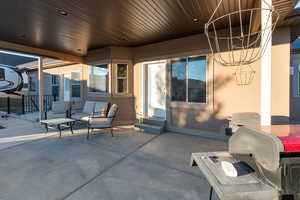 View of patio with a grill