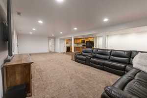 Living room featuring recessed lighting and light carpet